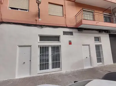 a white building with two doors and a balcony at District Key - Valencia, Plaza del Cedro in Valencia