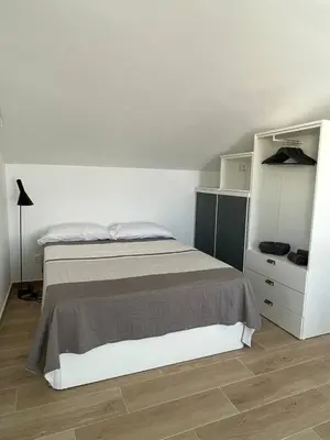 a bedroom with a bed and a white cabinet at More then a loft in Godella