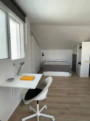 a bedroom with a bed and a desk and a bed at More then a loft in Godella