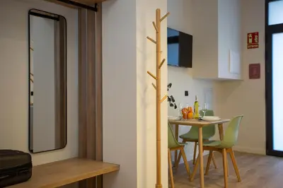 a small kitchen and dining room with a table and chairs at Nomad Haux Mestalla Apartments in Valencia