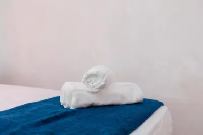 a stack of towels sitting on top of a bed at Chic & Cozy Stay in Valencia in Valencia