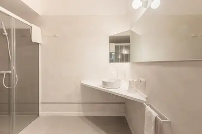 a white bathroom with a sink and a shower at Chic & Cozy Stay in Valencia in Valencia