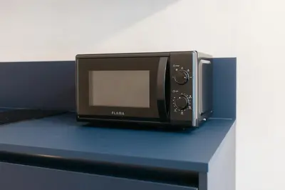 a microwave sitting on top of a blue table at Trendy Retreat in Valencia in Valencia