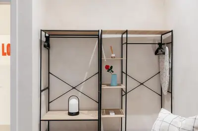 a room with a bed with a computer on a shelf at Trendy Retreat in Valencia in Valencia