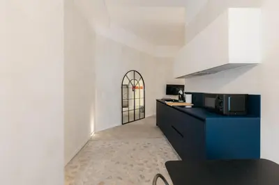 a kitchen with a black counter and a microwave at Trendy Retreat in Valencia in Valencia