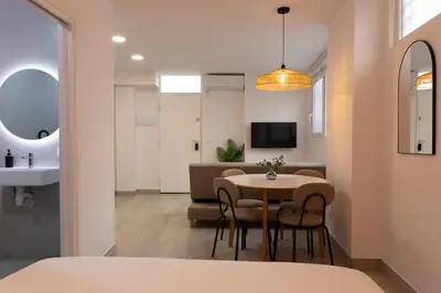a bedroom with a white bed with white pillows at Royal Flats in Valencia