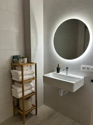 a bedroom with a bed and a couch and a kitchen at Royal Flats in Valencia