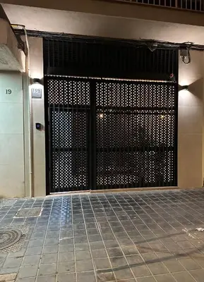 a metal gate in a building with a tile floor at Apartamento playa malvarrosa in Valencia