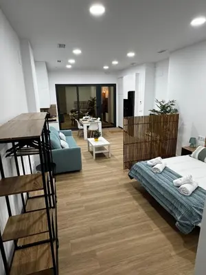 a room with a bed and a couch and a table at Apartamento playa malvarrosa in Valencia