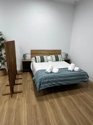 a bedroom with a bed with towels on it at Apartamento playa malvarrosa in Valencia