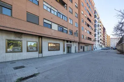 an empty street in front of a brick building at Les Arts Turia by Concept Flats in Valencia
