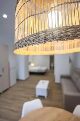 a light hanging over a table in a living room at Les Arts Turia by Concept Flats in Valencia