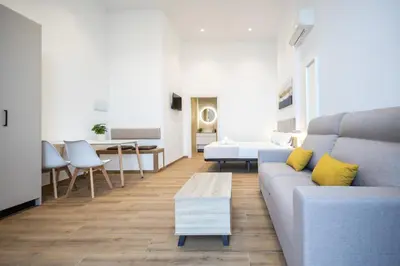 a living room with a couch and a table at Les Arts Plaza by Concept Flats in Valencia