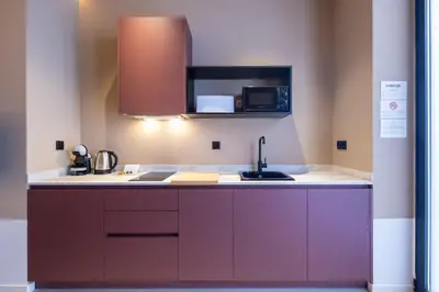 a kitchen with purple cabinets and a sink at Abastos by Concept Flats in Valencia