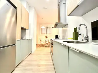 a kitchen and dining room with a table and chairs at Valentia Modern and Comfortable Beachside Style in Valencia