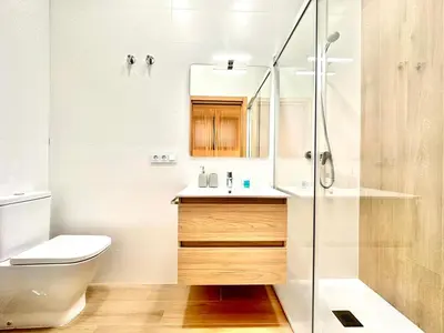 a bathroom with a toilet sink and a shower at Valentia Modern and Comfortable Beachside Style in Valencia