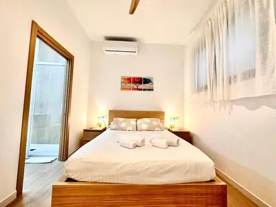 a living room and kitchen with a couch and a table at Valentia Modern and Comfortable Beachside Style in Valencia