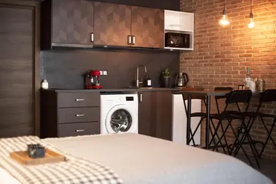 a kitchen with a washing machine and a table with chairs at New Loft Rusafa in Valencia