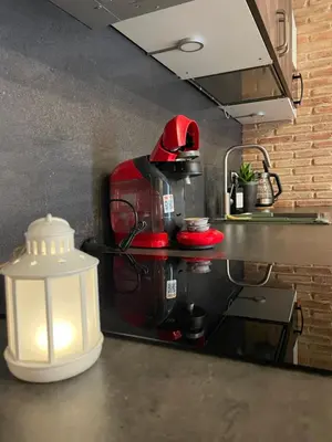 a red coffee maker sitting on a counter in a kitchen at New Loft Rusafa in Valencia