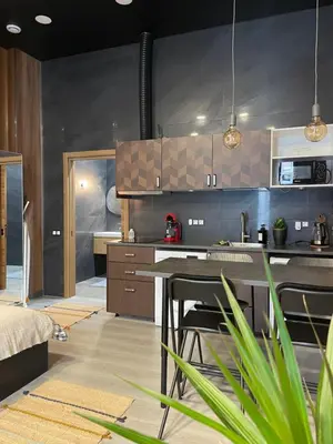 a kitchen with a table and chairs in a room at New Loft Rusafa in Valencia