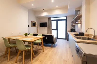 a kitchen and dining room with a table and chairs at Porto by Concept Flats in Valencia