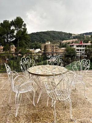 a table and chairs sitting around a table with a view at Cau de Serra 
