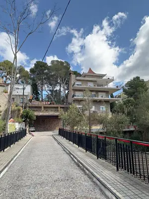 a bridge with a building in the background at Cau de Serra 