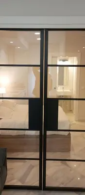 a view of a bedroom through a glass window at Apartamentos PADRE LUIS in Valencia