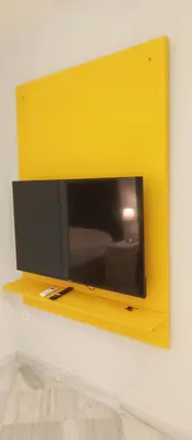 a yellow wall with a tv on a shelf at Apartamentos PADRE LUIS in Valencia