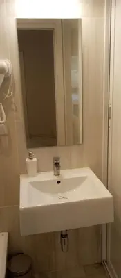 a bathroom with a white sink and a mirror at Apartamentos PADRE LUIS in Valencia