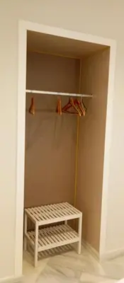 a closet with a shelf and a bench in a room at Apartamentos PADRE LUIS in Valencia