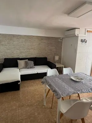 a living room with a couch and a table at Casa con Barbacoa en Urbanización Privada in Valencia