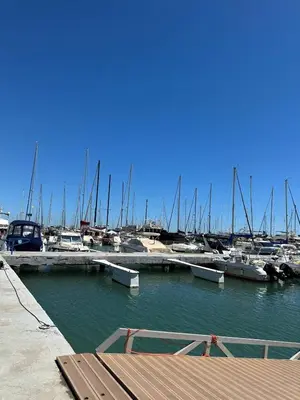 a marina with boats in the water and a bench at Casa con Barbacoa en Urbanización Privada in Valencia