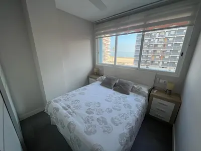 a small bedroom with a bed and a window at Paradise Cullera in Cullera