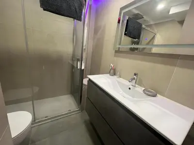 a bathroom with a sink and a shower and a toilet at Paradise Cullera in Cullera