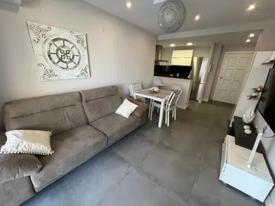 a living room with a couch and a table at Paradise Cullera in Cullera