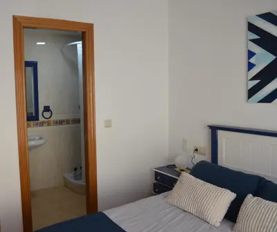a bedroom with a bed and a bathroom with a tub at Arbocer playa Puçol in Puzol