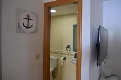 a bathroom with a toilet and a tub and a sink at Arbocer playa Puçol in Puzol