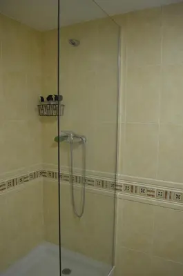 a shower with a glass door in a bathroom at Arbocer playa Puçol in Puzol