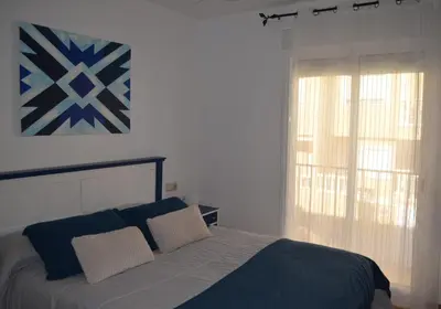 a bedroom with a bed and a window at Arbocer playa Puçol in Puzol