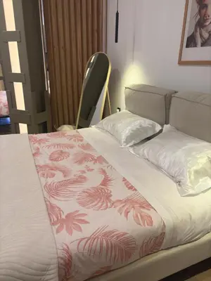 a bed in a room with a bedspread with flowers on it at Mestalla flats & Rut in Valencia