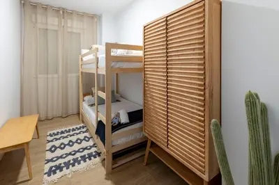 a room with bunk beds and a table and a chair at Travel Habitat Peset Aleixandre Apartments in Valencia
