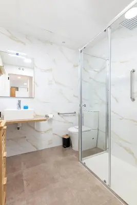 a bathroom with a glass shower and a toilet at Travel Habitat Peset Aleixandre Apartments in Valencia