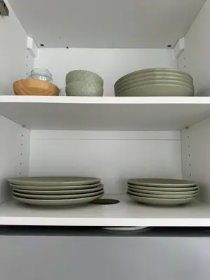a shelf with plates and bowls in a closet at Cozy apartment Valencia in Valencia
