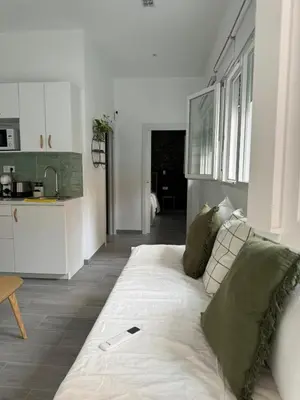 a couch with a cell phone on it in a living room at Cozy apartment Valencia in Valencia
