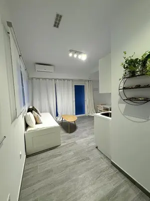 a living room with a couch and a kitchen at Cozy apartment Valencia in Valencia