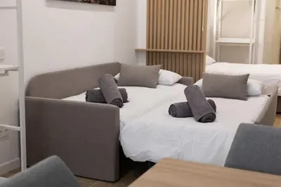 a living room with a couch and two beds at Luxury Apartments Oceanografic in Valencia
