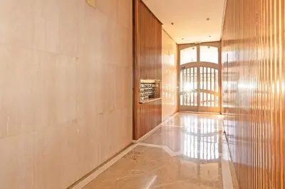 a hallway with wooden walls and a glass door at GuestReady - Delightful Valencia Retreat in Valencia