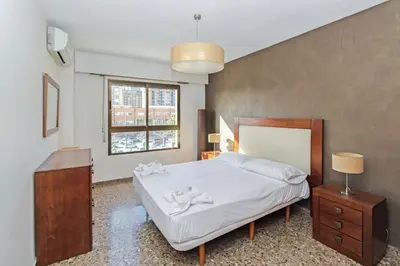 a bedroom with a bed and a dresser and a window at GuestReady - Delightful Valencia Retreat in Valencia
