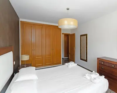 a bedroom with two beds and a dresser at GuestReady - Delightful Valencia Retreat in Valencia